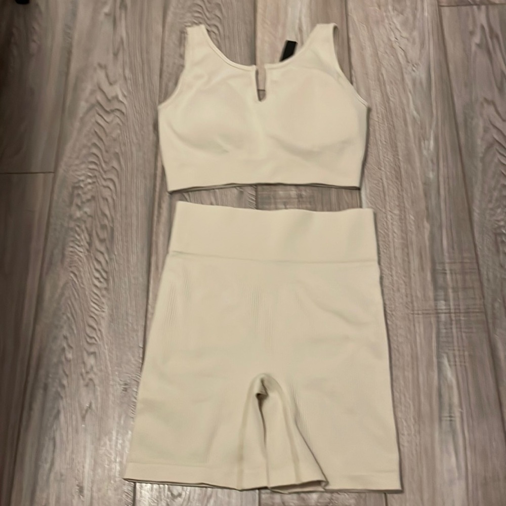 NWT 2 piece tan athletic set. Workout sports bra and shorts set
